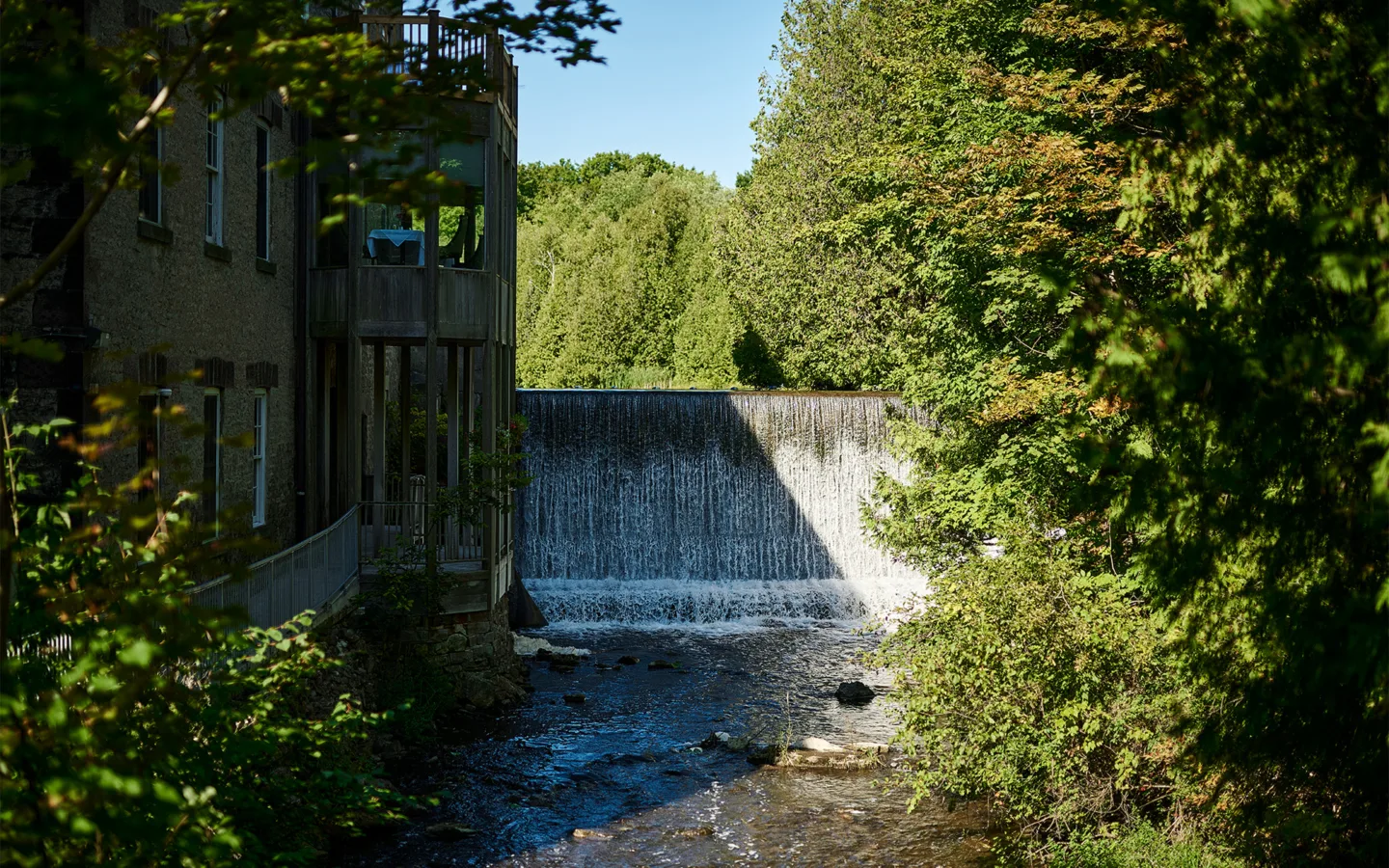 Historic Millcroft Inn overlooking the waterfall and landscaped grounds